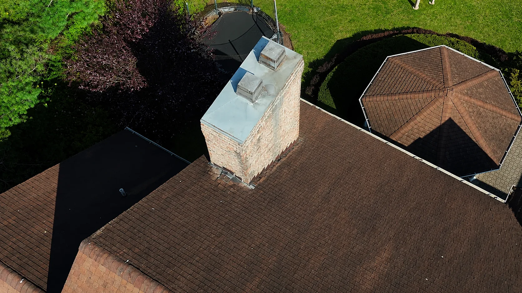 Storm-damaged roof with wind-lifted shingles after a Long Island nor'easter