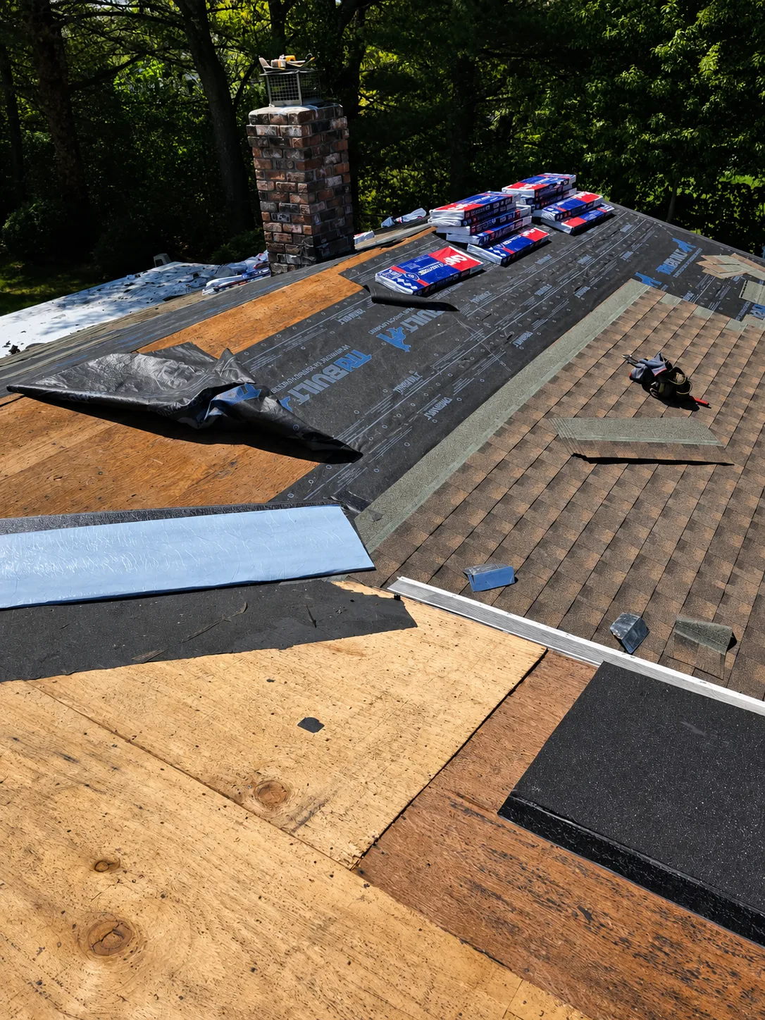 Emergency roof tarping to stop water intrusion after a Long Island storm